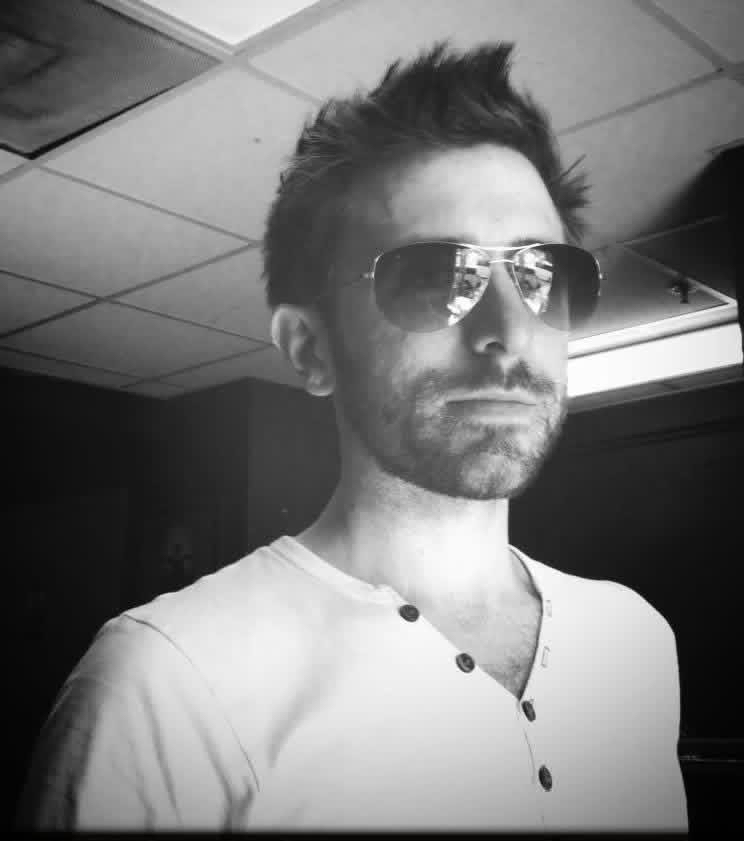 Black-and-white self-portrait of Chris LoPresto in aviator sunglasses and a henley